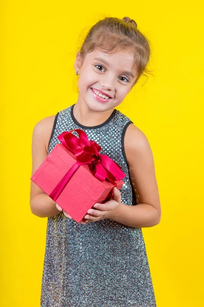Beautiful little girl with a gift — Stock Photo, Image
