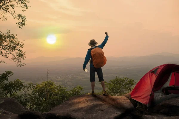 Mochilero levantando las manos en la montaña en el camping por la mañana — Foto de Stock