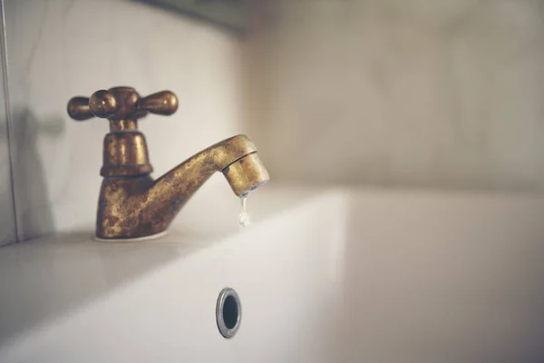 Water tap with dripping waterdrop. Water leaking, saving concept — ストック写真