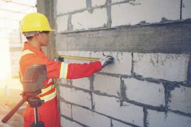 İş sırasında lazer ölçüm seviyesine sahip teknisyen