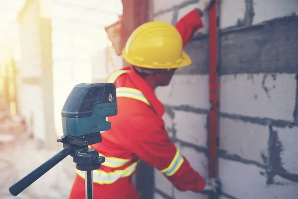 Technician with Laser measurement level during work