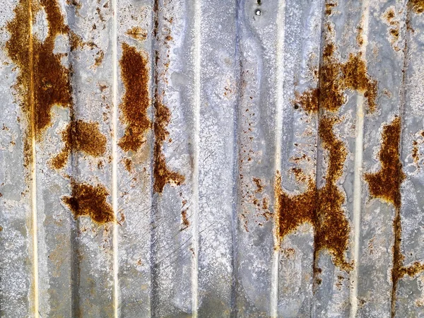 Parede de metal marrom enferrujado com padrões amarelos. metal ferrugem textura fundo . — Fotografia de Stock