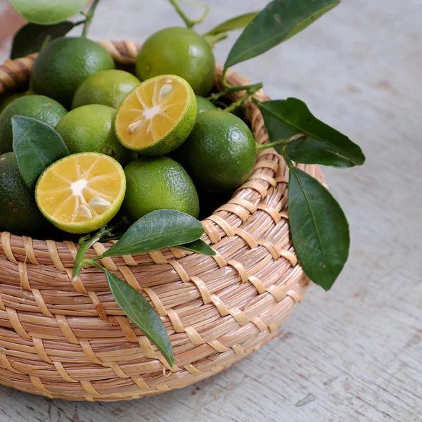 Kumquat zelené ovoce na dřevěné pozadí — Stock fotografie