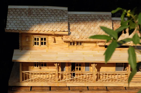 Amazing handmade product from tongue depressor stick, mini model house with creative architect, craft product as a residential building in evening