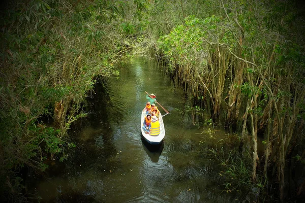 Mulher remando barco linha através da floresta — Fotografia de Stock