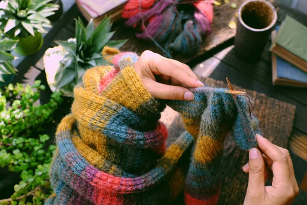 Top view at home balcony, hand hold piece of paper, knit colorfu — Zdjęcie stockowe