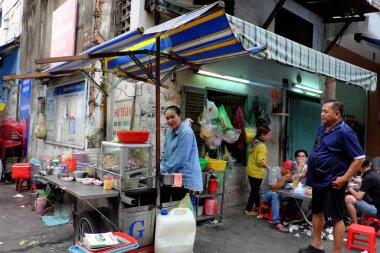 Vietnamese female chef cook noodles soup at outdoor restaurant f
