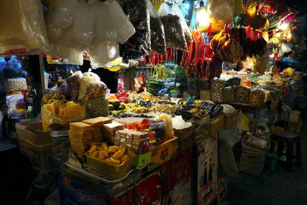 Indoor dried food market with many stalls in yellow lamp — Stockfoto