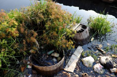 Pollution river from litter at Ho Chi Minh city, Viet Nam, many trash from plastic bag, bottle, packaging in water make dirty canal at morning