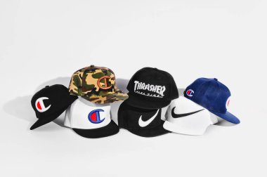 Fashionable Stussy, Thrasher, Supreme, Champion and Nike baseball caps isolated on white background clipart