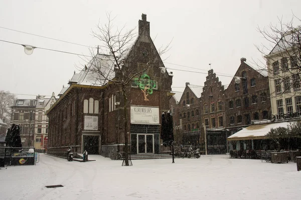 The Korenmarkt square in the center of Arnhem during snowfall Stock Photo