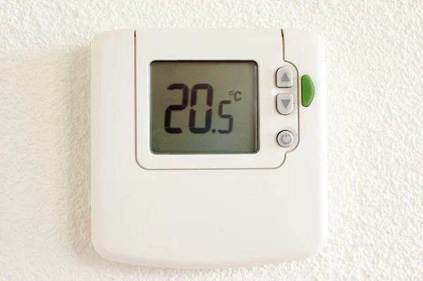 Digital climate control with white wall in the background