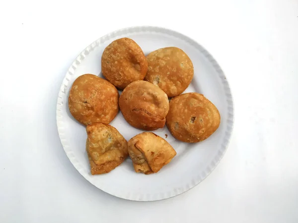 Hindistan çölü taze kachori beyaz arka plana izole edilmiş beyaz bir tabak koyun.
