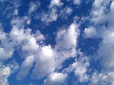 Mavi gökyüzünde beyaz parlayan bulutlar