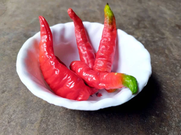 Some Fresh Red Chilli Put White Bowl Isolated Stone Background — Stockfoto