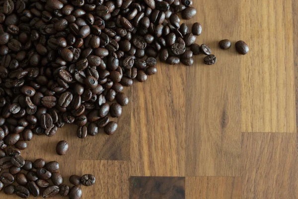 Dunkle Geröstete Kaffeebohnen Großaufnahme Auf Einem Holztisch — Stockfoto