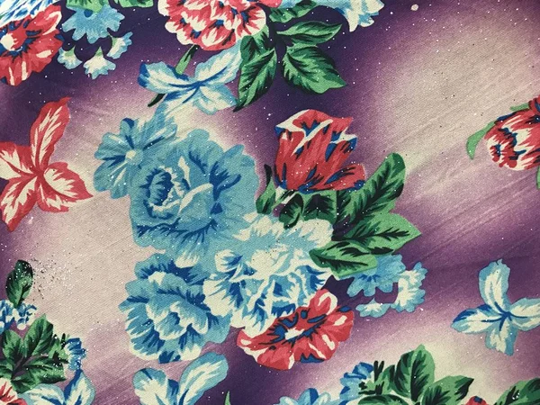 Beautiful colorful flowers on batik background — Stock Photo, Image