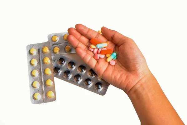 Hand holding pills on isolated white background — Stock Photo, Image