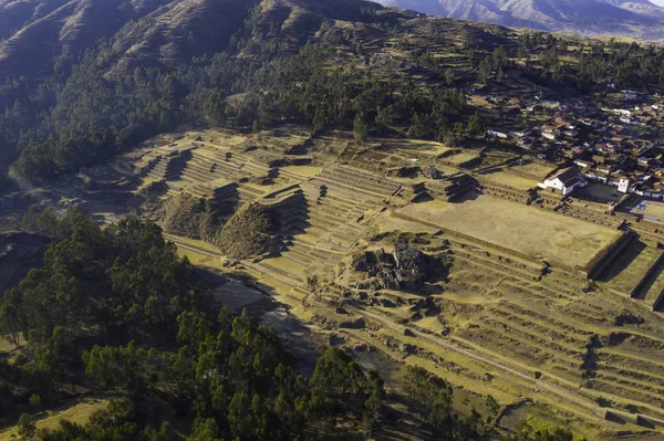 Aerial view of Chinchero Archaeological Site. The ruins at Chinchero consist of a series of nested inca terraces rising up to a plateau upon which sits a church.