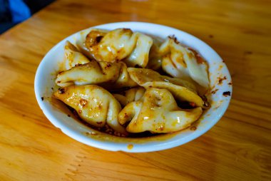 Yerel zevkler. Çin mantısı (jiaozi) acı sichu soslu ve biberli. Chengdu şehri, Çin