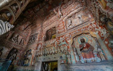 Buddhist caves with statues and sculptures on the walls and ceilings. Yungang Grottoes  near Datong, Shanxi Province, China clipart