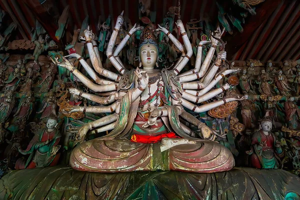 Fine ancient figure of buddhist goddess with 24 arms. Altar statue made in wood located in Shuanglin Temple (or Zhongdu Temple), outskirts Pingyao Old City, Shanxi province, China — Stock Image Fine Ancient Figure Buddhist Goddess Arms Altar Statue Made Wood Stock Photo