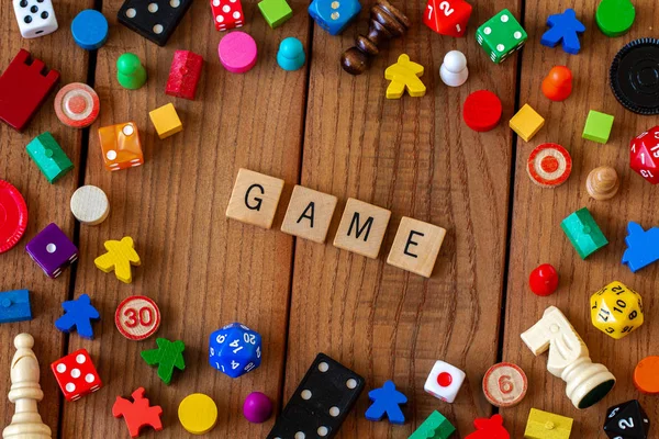 Game Spelled Out Wooden Letter Tiles Surrounded Dice Cards Other — Stock Photo, Image