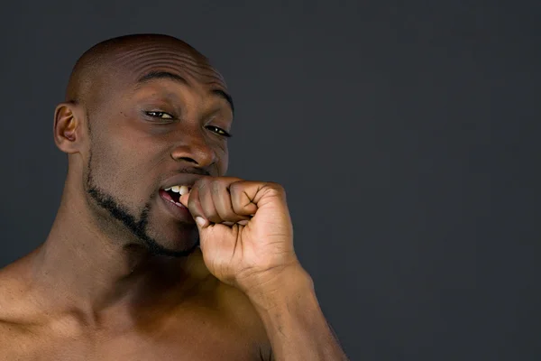 African american man biting nails — Stock Photo, Image