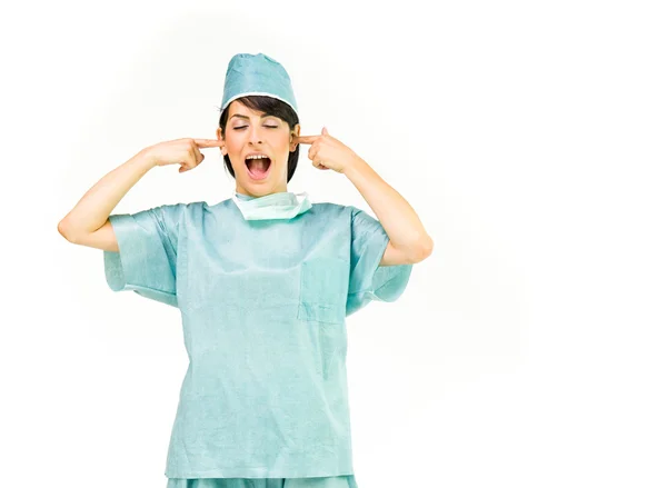 Doctor woman plugging ears — Stock Photo, Image