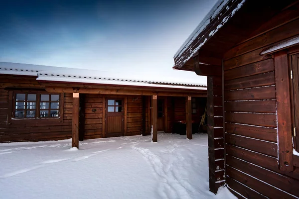 Log cabin retreat in deep snow covered landscape