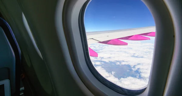 Looking through aircraft window at wing — Stock Photo, Image