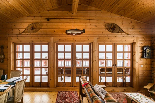 Wood clad Lliving room and doors in log cabin — Stock Photo, Image