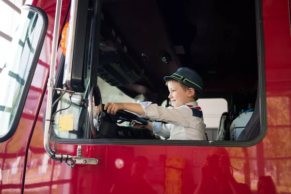 Young boy in driving seat of truck