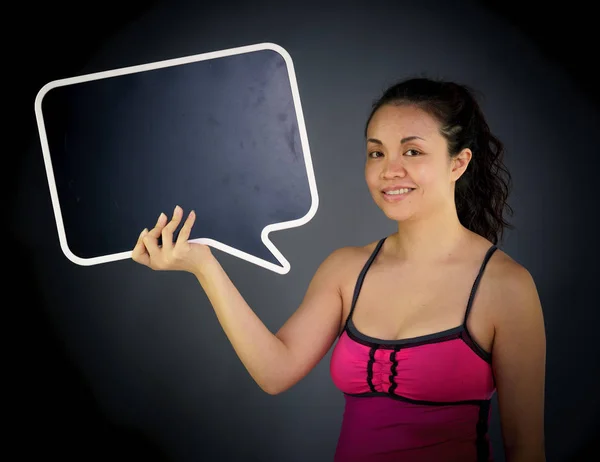 Woman looking at camera holding speech bubble — Stock Photo, Image