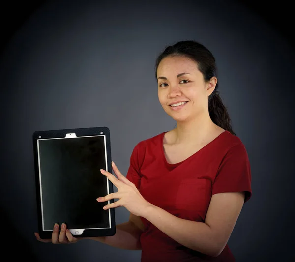 Woman looking at camera holding digital tablet Royalty Free Stock Photos