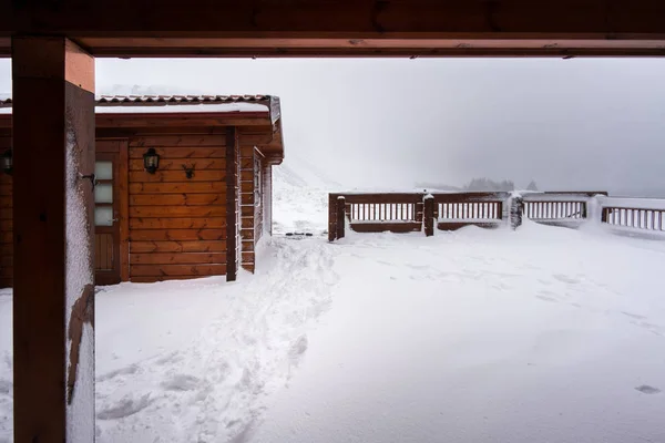 Cosy log cabin in snow covered landscape