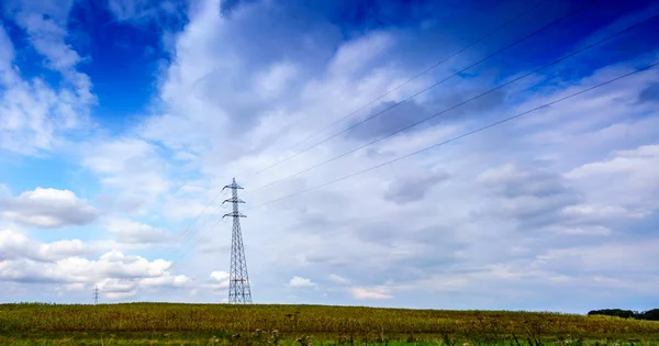 Panoramic shot of electricity pylon in field — Stock Photo, Image