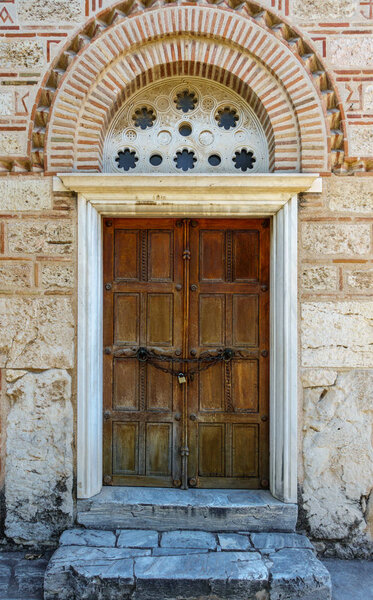 Historic closed door leading to Church of the Holy Apostles, Athens, Greece