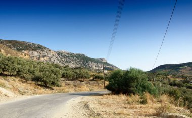 Yol ağaçlar ve dağ gökyüzü, Crete, Yunanistan
