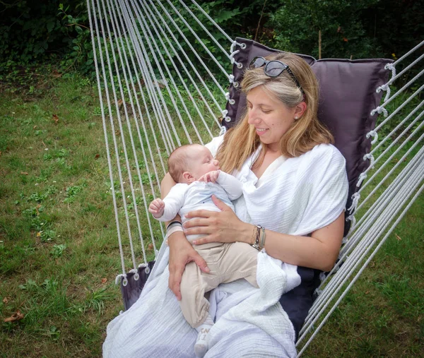 Madre con el bebé durmiendo en la hamaca — Foto de Stock