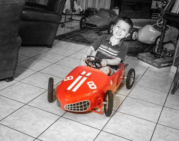 Feliz Niño Montando Coche Juguete Casa —  Fotos de Stock