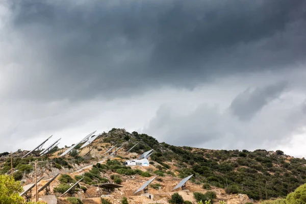 Solar panels on mountain landscape against sky, Crete, Greece
