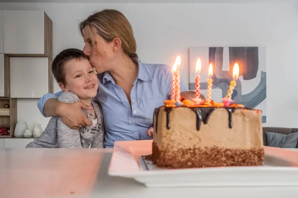 Mother celebrating birthday with her son at home