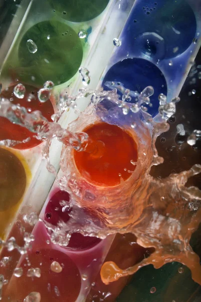 Photo of paints being splashed with water — Stock Photo, Image