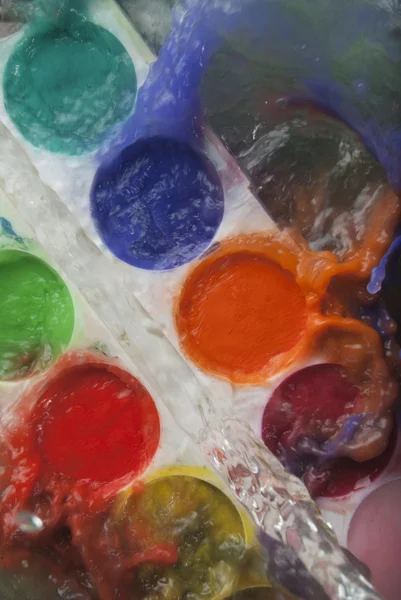 Photo of color paints set splashed with water — Stock Photo, Image