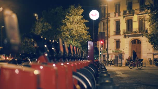 Estación de bicicletas compartidas por la noche en una ciudad — Vídeos de Stock