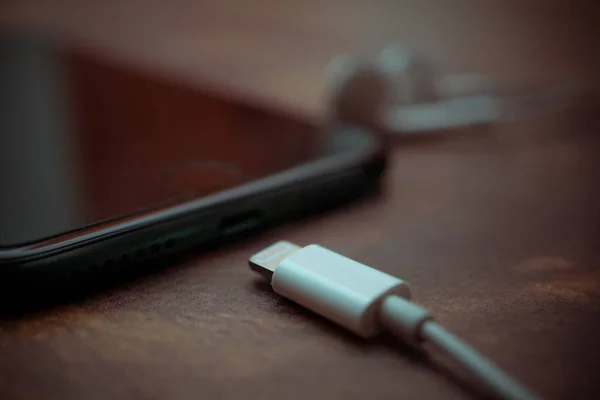 Nizhyn, Ukrayna / 26 Kasım 2019: iphone 7 + ve yeni elma yıldırımlı kulaklıkların kapatılması