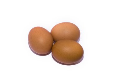 Three brown chicken eggs on a white background. isolate