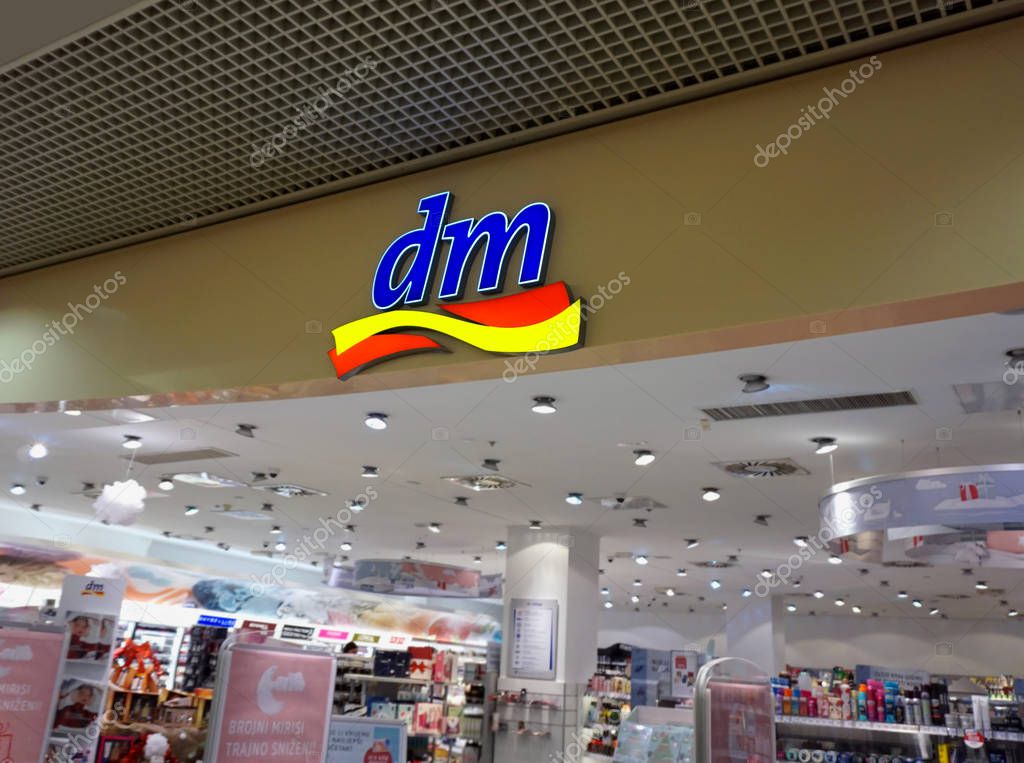 Rijeka, Croatia, January 4th, 2019. Logo of DM, initials of Drogerie Markt, above the entrance into the store. It is a retail chain of stores selling cosmetics, hygiene stuff an organic food