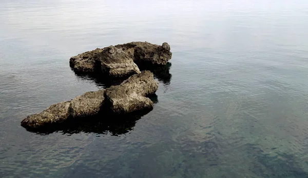 Dos grandes rocas que emergen de la superficie del mar — Foto de Stock